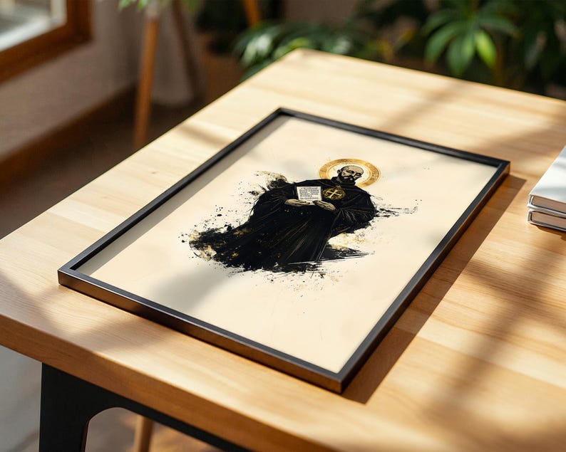 May include: A framed art print featuring a stylized illustration of a bearded monk in a black habit with a gold halo. The figure holds a white document and a circular emblem. The artwork uses black ink splatters on a cream background.