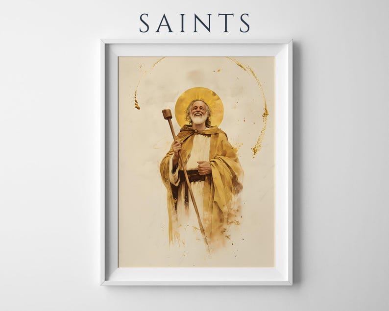 May include: A framed wall art print titled SAINTS featuring a watercolor-style illustration of a bearded figure in golden robes holding a wooden staff. The figure has a circular gold halo behind their head, set against a cream background.