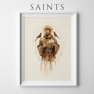 May include: A framed wall art print featuring the text SAINTS at the top. The illustration depicts a bearded figure in a brown robe with a gold halo, holding white flowers, with a small bird perched on each shoulder, rendered in a watercolour style.