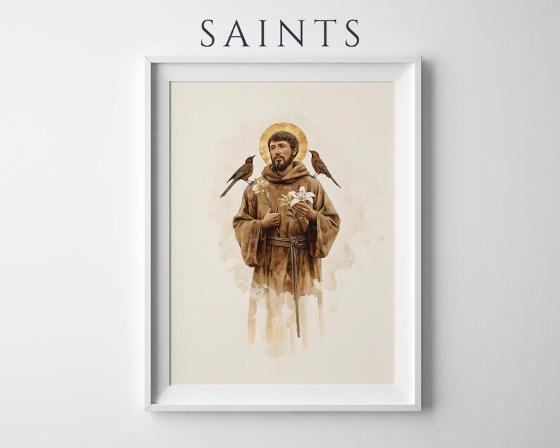 May include: A framed wall art print featuring the text SAINTS at the top. The illustration depicts a bearded figure in a brown robe with a gold halo, holding white flowers, with a small bird perched on each shoulder, rendered in a watercolour style.