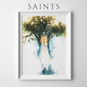 May include: A framed wall art print titled SAINTS featuring a watercolour illustration of a figure in a white robe and crown with hands clasped in prayer, positioned before a large tree with green and yellow foliage and a glowing golden halo.