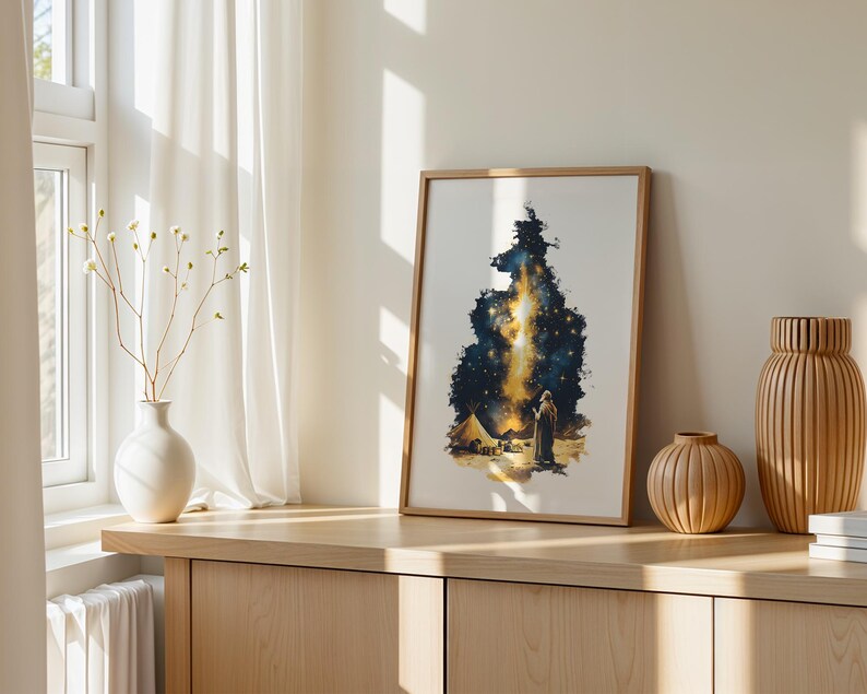 May include: A framed vertical art print featuring a dark blue and gold celestial scene with a figure standing in a desert landscape near a tent, illuminated by a bright, glowing vertical light formation resembling a nebula or starry sky.