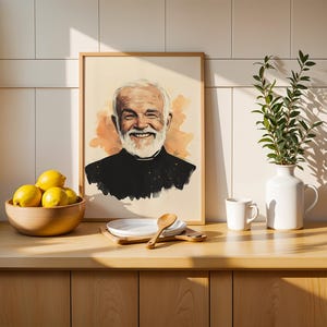 May include: A framed portrait illustration of a smiling older person with a white beard, wearing a black clerical shirt with a white collar, set against a soft orange watercolour background. The artwork is displayed in a light wood frame.