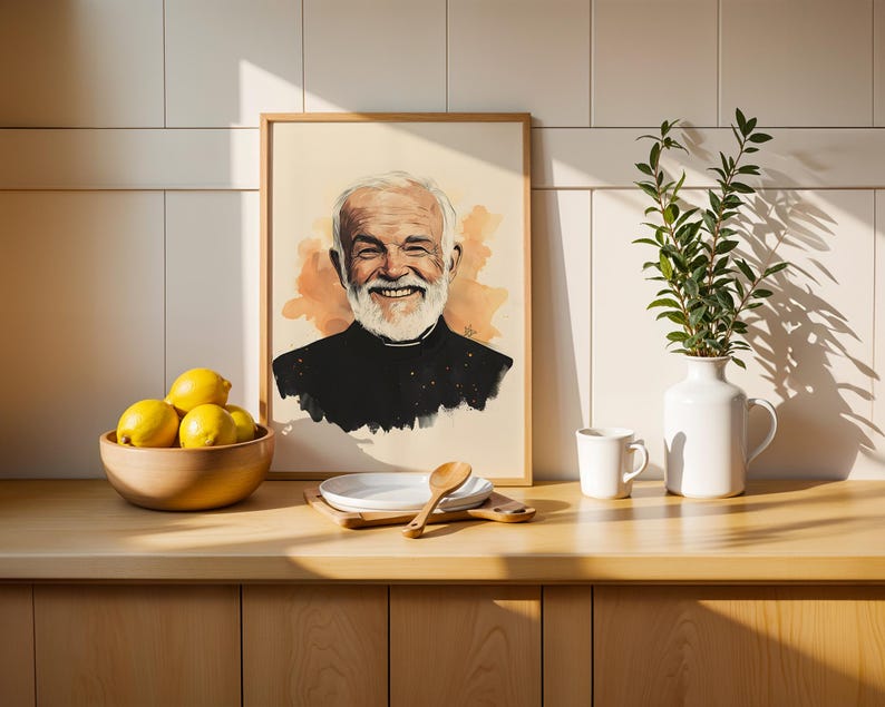 May include: A framed portrait illustration of a smiling older person with a white beard, wearing a black clerical shirt with a white collar, set against a soft orange watercolour background. The artwork is displayed in a light wood frame.