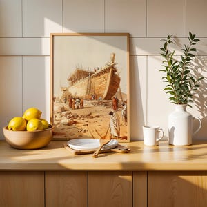 May include: A framed print depicting a large wooden ship under construction in a desert landscape, displayed next to a wooden bowl of yellow lemons, a stack of white plates with a wooden spoon, a white mug, and a white vase with green leaves.