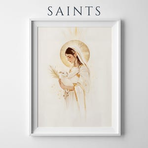 May include: A framed wall art print featuring the word SAINTS at the top. The illustration depicts a figure in white robes with a gold halo, holding a small white lamb and a palm frond, rendered in soft gold and cream tones on a light background.