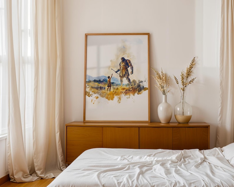 May include: A framed watercolour print depicting a small figure reaching towards a large, towering giant in a golden field. The artwork features muted tones of yellow, blue, and brown, showcasing a dramatic scene of scale and interaction.