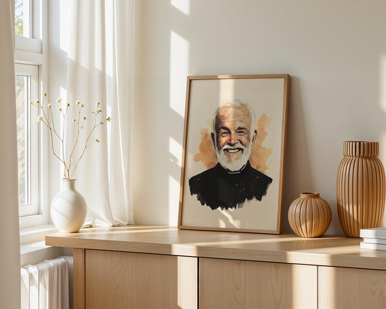 May include: A framed portrait print featuring a watercolour-style illustration of a smiling older person with a white beard, wearing a black collared shirt, set against a soft beige background with warm orange-toned watercolour splashes.