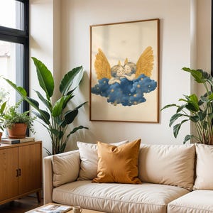 May include: A framed wall art print featuring two cherubs with large golden wings resting on a dark blue cloud filled with small yellow stars. The illustration is set against a cream-coloured background and is displayed in a thin wooden frame.