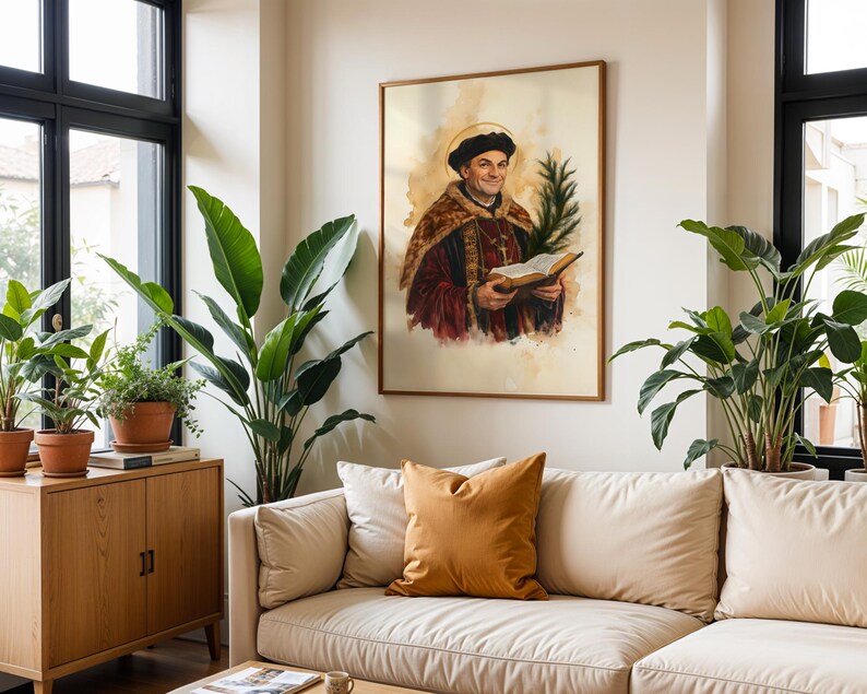 May include: A framed wall art print featuring a watercolour-style portrait of a historical figure wearing a dark cap and a fur-trimmed robe, holding an open book and a green palm frond, with a golden halo depicted behind the head.
