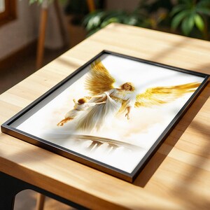 May include: A framed print featuring an illustration of a winged figure in a white robe with large golden wings, carrying a small child in white clothing above a bridge, set against a soft, light-colored background with golden highlights.