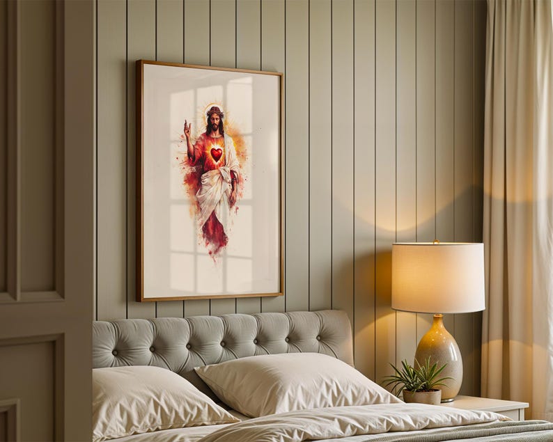May include: A framed wall art print featuring a watercolor-style illustration of Jesus Christ with a glowing Sacred Heart. The figure is depicted in white and red robes with a crown of thorns, set against a soft, abstract background of warm light.