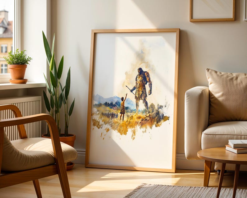 May include: A framed watercolour-style art print featuring a large, muscular figure standing over a smaller person in a golden-hued landscape. The scene includes distant mountains and a group of figures in the background, rendered in shades of yellow, brown, and blue.