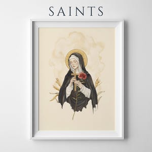 Puede incluir: Una l&aacute;mina enmarcada titulada SAINTS con la ilustraci&oacute;n de una figura con h&aacute;bito negro y velo blanco, sosteniendo una cruz de madera y una rosa roja. La figura tiene un halo dorado sobre un fondo crema con tallos de trigo.