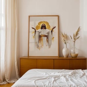 May include: A framed vertical wall art print featuring a central figure with long dark hair and a beard, wearing a white robe with a gold sash, arms raised upwards, set against a radiant gold halo and abstract gold paint splatters.