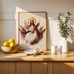May include: A framed wall art print depicting a central figure with a crown and halo, flanked by two winged angels, holding a golden orb. The artwork features a white and red color palette with a watercolor-style aesthetic and a light wood frame.