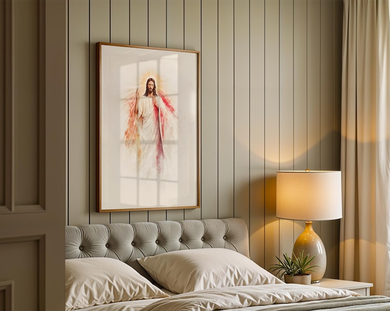 May include: A framed wall art print featuring a watercolor-style illustration of a figure with long brown hair and a beard, wearing a white robe with red and light blue accents, with a glowing golden halo effect surrounding the head.