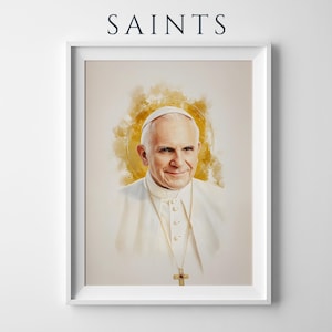 Pu&ograve; includere: Una stampa ritratto incorniciata con la parola SAINTS in alto. L'opera raffigura un'illustrazione in stile acquerello di Papa Giovanni Paolo II che indossa una veste bianca e una croce dorata, su uno sfondo con un morbido alone circolare dorato.