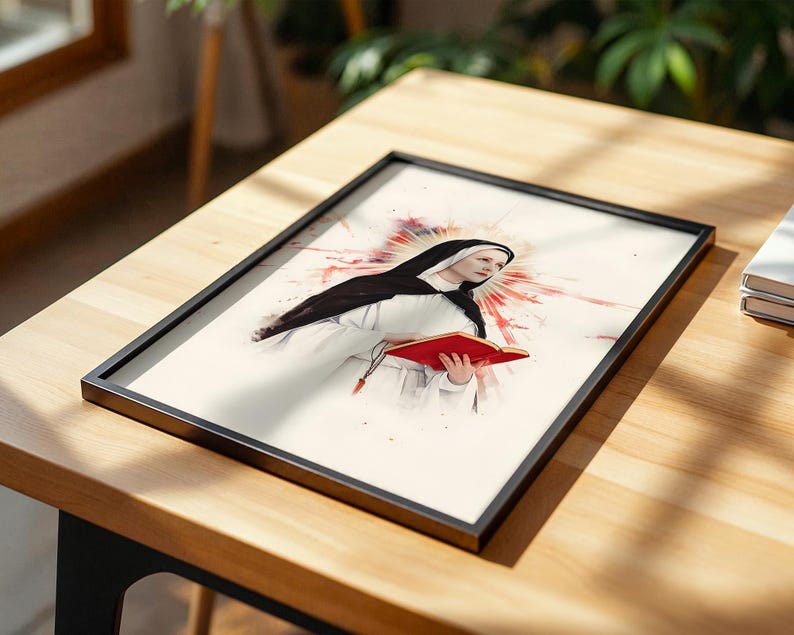 May include: A framed print featuring a watercolor-style illustration of a nun wearing a black and white habit, holding an open red book. Behind the figure is a vibrant red and orange sunburst effect, all set against a light cream background.
