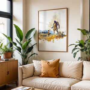 May include: A framed wall art print featuring a watercolor-style illustration of a small figure standing before a towering giant in a golden field. The artwork uses warm yellow, brown, and blue tones to depict a scene of scale and contrast.