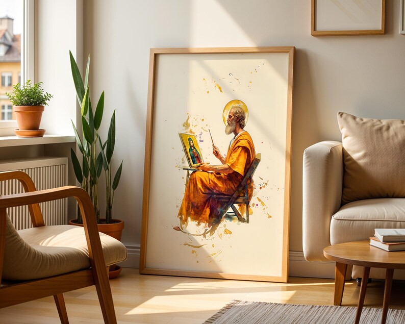 May include: A framed vertical wall art print featuring a watercolour-style illustration of a bearded figure in orange robes sitting on a chair, holding a paintbrush and a small framed portrait of a person with a halo against a cream background.