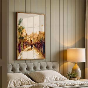 May include: A framed vertical wall art print depicting a historical scene of a figure riding a donkey through a crowd of people in a desert city. The artwork features warm golden tones, palm trees, and stone architecture under a bright sky.