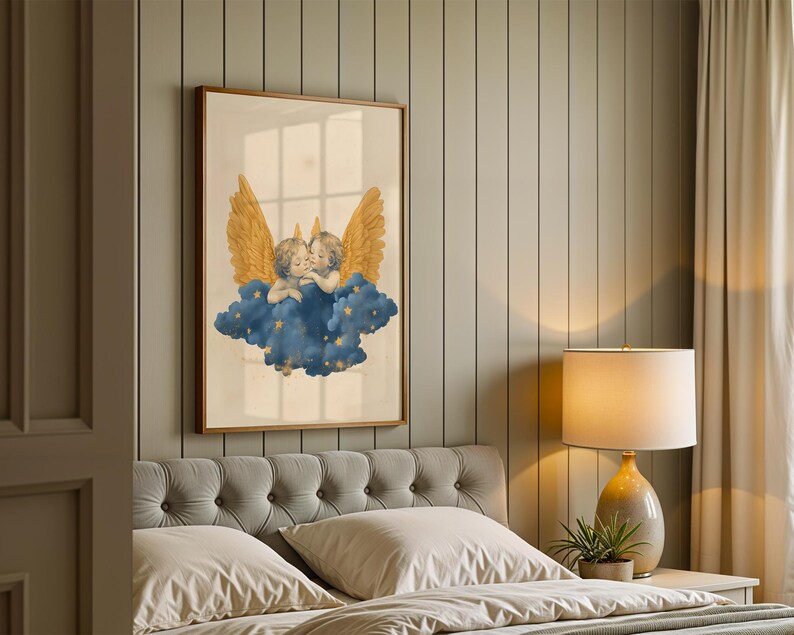 May include: A framed wall art print featuring two cherubs with large golden wings resting upon a dark blue cloud. The cloud is decorated with small golden stars. The artwork is presented in a simple wooden frame and displayed on a wall.