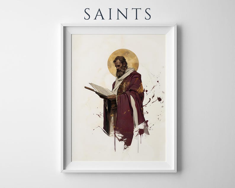 May include: A framed wall art print titled SAINTS featuring a bearded figure in a deep maroon robe and white shawl reading an open book. A golden circular halo sits behind the head, with abstract paint splatters in dark red and gold tones.