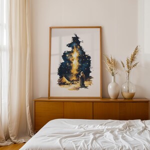 May include: A framed vertical art print featuring a watercolour-style illustration of a lone figure standing in a desert landscape under a dark, starry night sky with a bright, vertical golden light beam extending upward from the horizon.