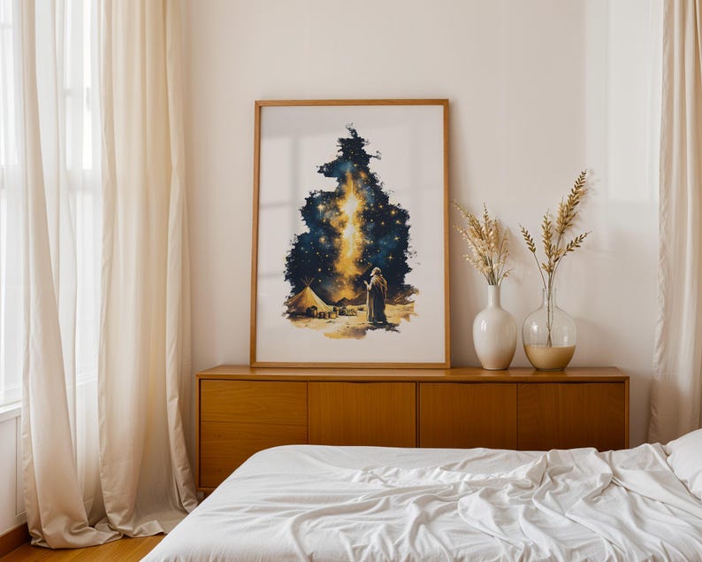 May include: A framed vertical art print featuring a watercolour-style illustration of a lone figure standing in a desert landscape under a dark, starry night sky with a bright, vertical golden light beam extending upward from the horizon.