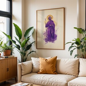 May include: A framed wall art print featuring a stylized illustration of a bearded figure in a purple robe holding a staff, with a golden halo above the head. The artwork uses watercolor-style purple and yellow splashes on a light background.