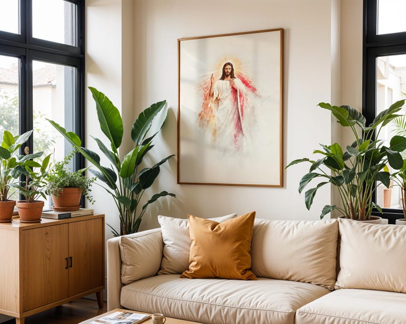 May include: A framed wall art print depicting a figure with long brown hair and a beard, wearing a white robe with red accents, surrounded by a golden light halo. The artwork is displayed on a plain wall above a beige sofa with a mustard pillow.