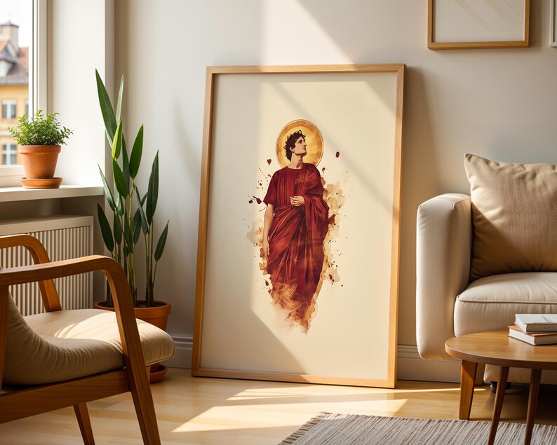 May include: A framed vertical wall art print featuring a central illustration of a person in a deep red robe with a golden halo behind their head. The figure is depicted in a watercolor style with abstract paint splatters against a cream background.