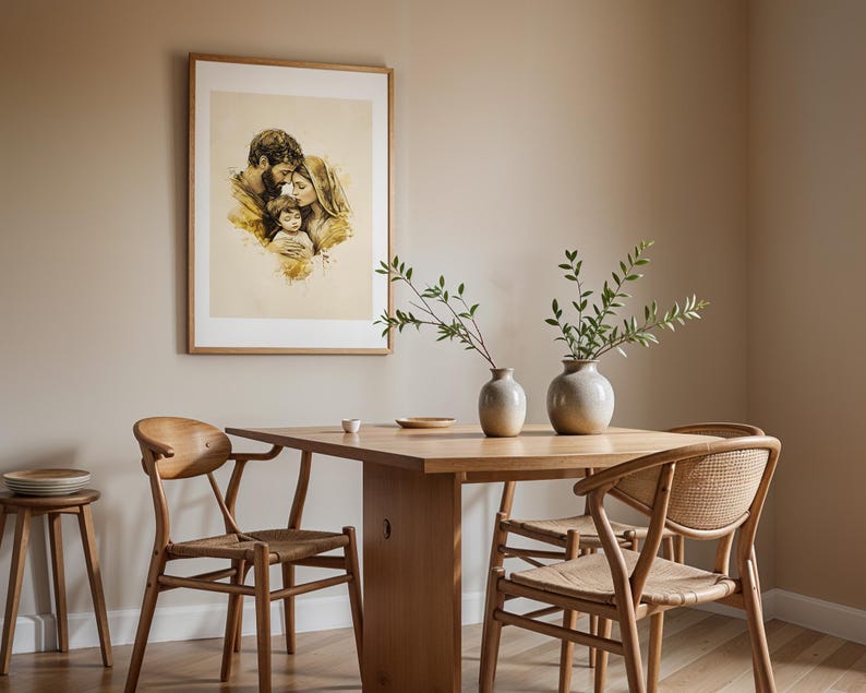 May include: A framed wall art print featuring a sepia-toned watercolor illustration of a family of three, displayed above a wooden dining table with two ceramic vases containing green leafy branches and four wooden chairs with woven seats.