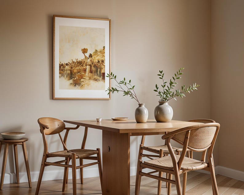 May include: A rectangular framed print depicting a historical scene with a central figure holding a basket, displayed above a light wood dining table. Two ceramic vases with green leafy branches sit on the table, surrounded by four wooden chairs.