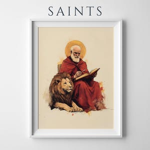 Peut inclure: Une impression d'art encadr&eacute;e avec le texte SAINTS en haut. L'illustration repr&eacute;sente une figure barbue en robe rouge avec une aur&eacute;ole dor&eacute;e, &eacute;crivant dans un livre, accompagn&eacute;e d'un lion au repos, le tout dans un style aquarelle.