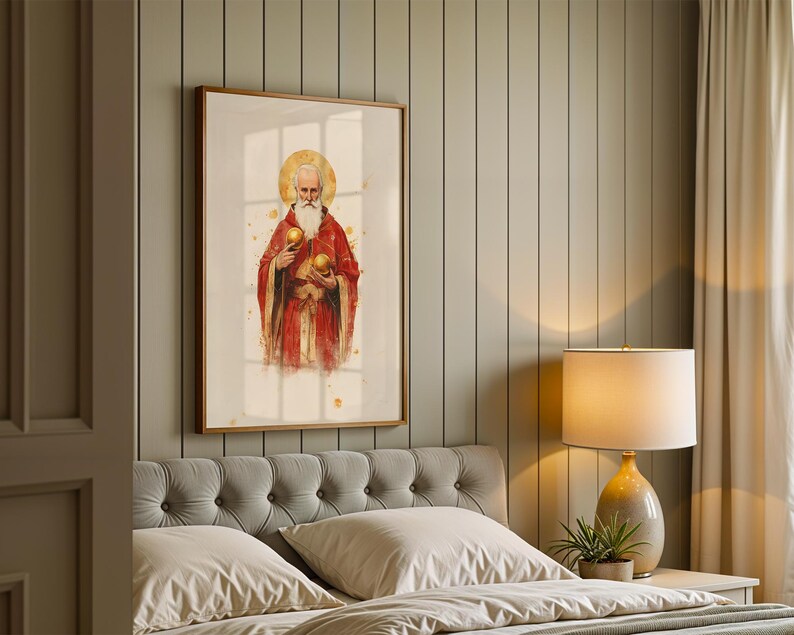 May include: A framed vertical wall art print featuring a bearded figure in a red robe with a gold halo, holding two golden spheres. The artwork has a watercolor style with gold splatter accents, presented in a simple wooden frame on a wall.