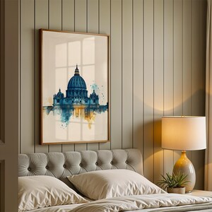May include: A framed wall art print featuring a watercolour-style illustration of St. Peter's Basilica in shades of deep blue and gold. The artwork depicts the iconic dome and architectural structure with artistic paint splatters and reflections.