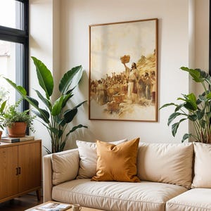 May include: A framed wall art print depicting a historical scene with a central figure holding a basket aloft before a crowd, rendered in muted earth tones. The artwork is displayed on a plain wall above a beige sofa with a mustard yellow cushion.