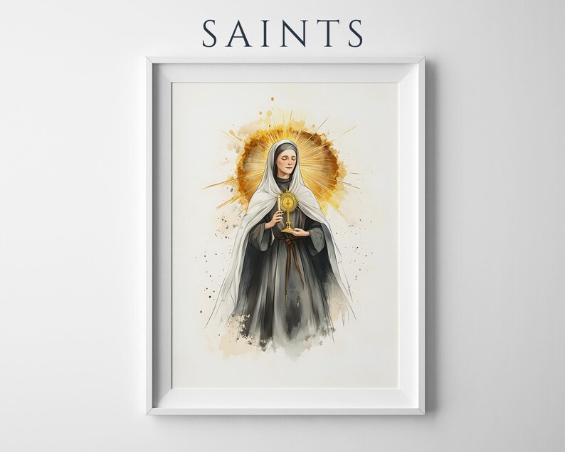 Pode incluir: Uma impress&atilde;o de arte emoldurada intitulada SAINTS apresentando uma ilustra&ccedil;&atilde;o em aquarela de uma figura com h&aacute;bito escuro e v&eacute;u branco segurando um ostens&oacute;rio dourado. A figura est&aacute; centralizada contra um fundo circular dourado.