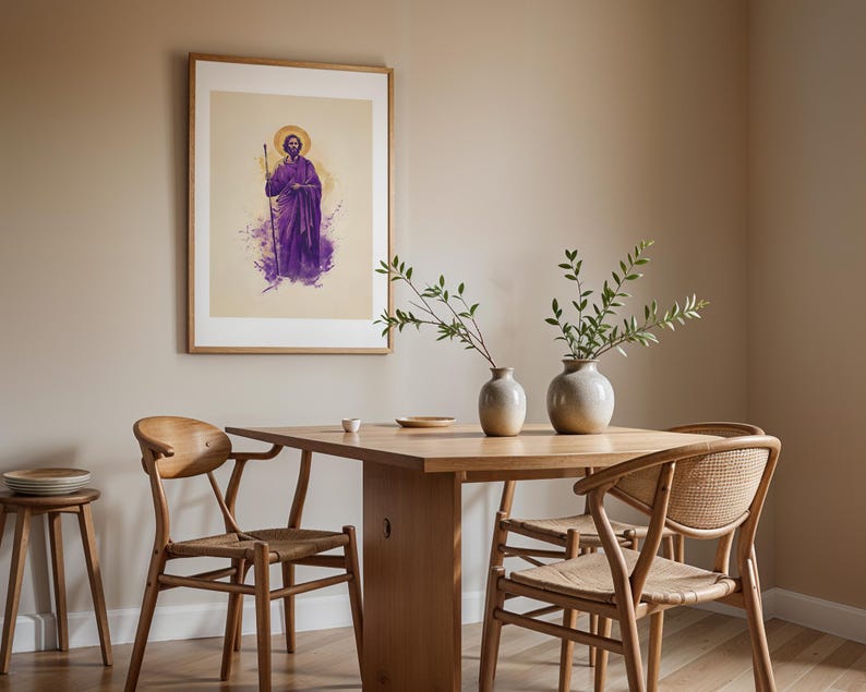May include: A framed wall art print featuring a figure in purple robes holding a staff with a golden halo, displayed above a wooden dining table with two ceramic vases containing green branches and three wooden chairs with woven seats.