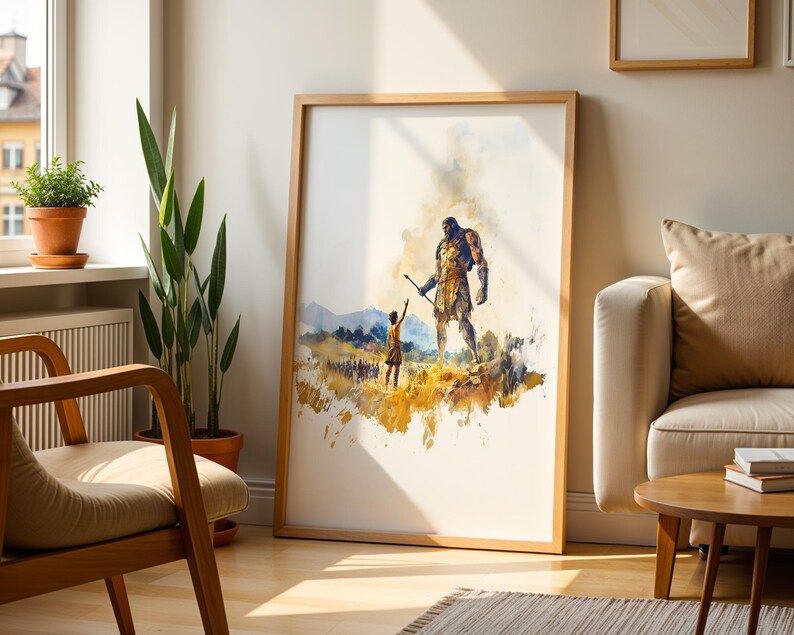 May include: A framed watercolor-style art print featuring a large, muscular figure standing over a smaller person in a golden-hued landscape. The scene includes distant mountains and a group of figures in the background, rendered in shades of yellow, brown, and blue.