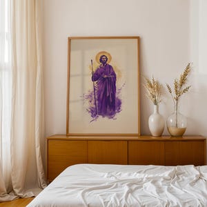 May include: A framed vertical wall art print featuring a stylized illustration of a bearded figure in purple robes holding a staff, set against a light background with a golden halo, displayed in a wooden frame with a clean, simple aesthetic.