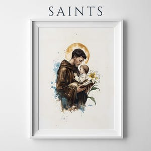 Puede incluir: Una l&aacute;mina de arte mural enmarcada con el texto SAINTS en la parte superior. La ilustraci&oacute;n muestra a una figura con t&uacute;nica marr&oacute;n sosteniendo a un ni&ntilde;o peque&ntilde;o y un libro, con un halo amarillo, un lirio blanco y salpicaduras de acuarela azul.