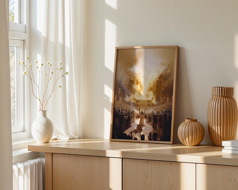 May include: A framed rectangular wall art print depicting a large crowd gathered before a glowing structure with a central figure raising arms toward a bright light. The artwork features warm golden and brown tones, displayed in a light wood frame.