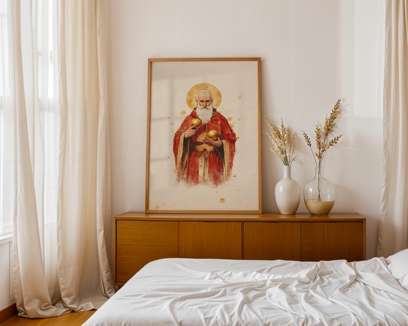 May include: A framed vertical wall art print featuring a watercolour-style illustration of a bearded figure with a golden halo, wearing a red robe and holding two golden spheres, displayed in a light wood frame on a wooden sideboard.
