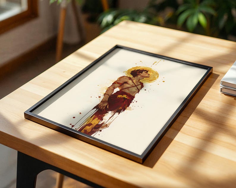 May include: A framed art print featuring a watercolour-style illustration of a person with a golden halo, wearing red and white garments. The figure is depicted in profile against a cream background with red and yellow paint splatters.