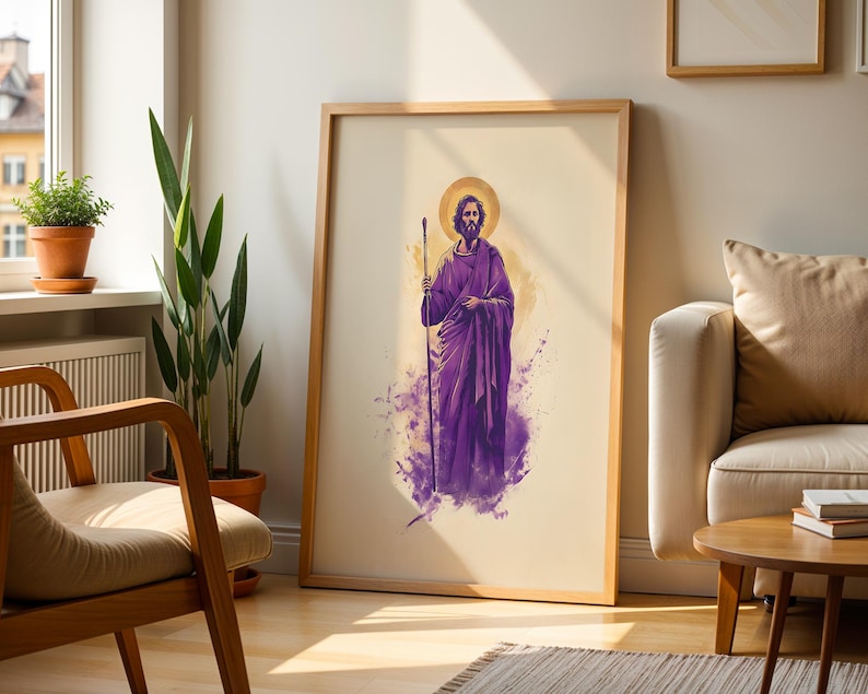 May include: A framed vertical wall art print featuring a bearded figure in a purple robe holding a staff. The figure has a golden halo behind their head, set against a cream background with purple watercolor-style splashes at the base.