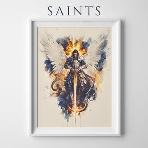 May include: A framed wall art print titled SAINTS featuring a watercolour-style illustration of a winged figure in silver armour holding a glowing sword. The figure has large white wings and is surrounded by splashes of blue, orange, and yellow paint.