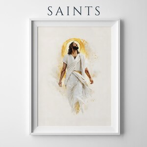 Puede incluir: Una impresi&oacute;n de arte de pared enmarcada con la palabra SAINTS en la parte superior. La obra muestra una figura con cabello oscuro largo y barba, vistiendo t&uacute;nicas blancas, mirando hacia arriba con un efecto de halo dorado detr&aacute;s de la cabeza.